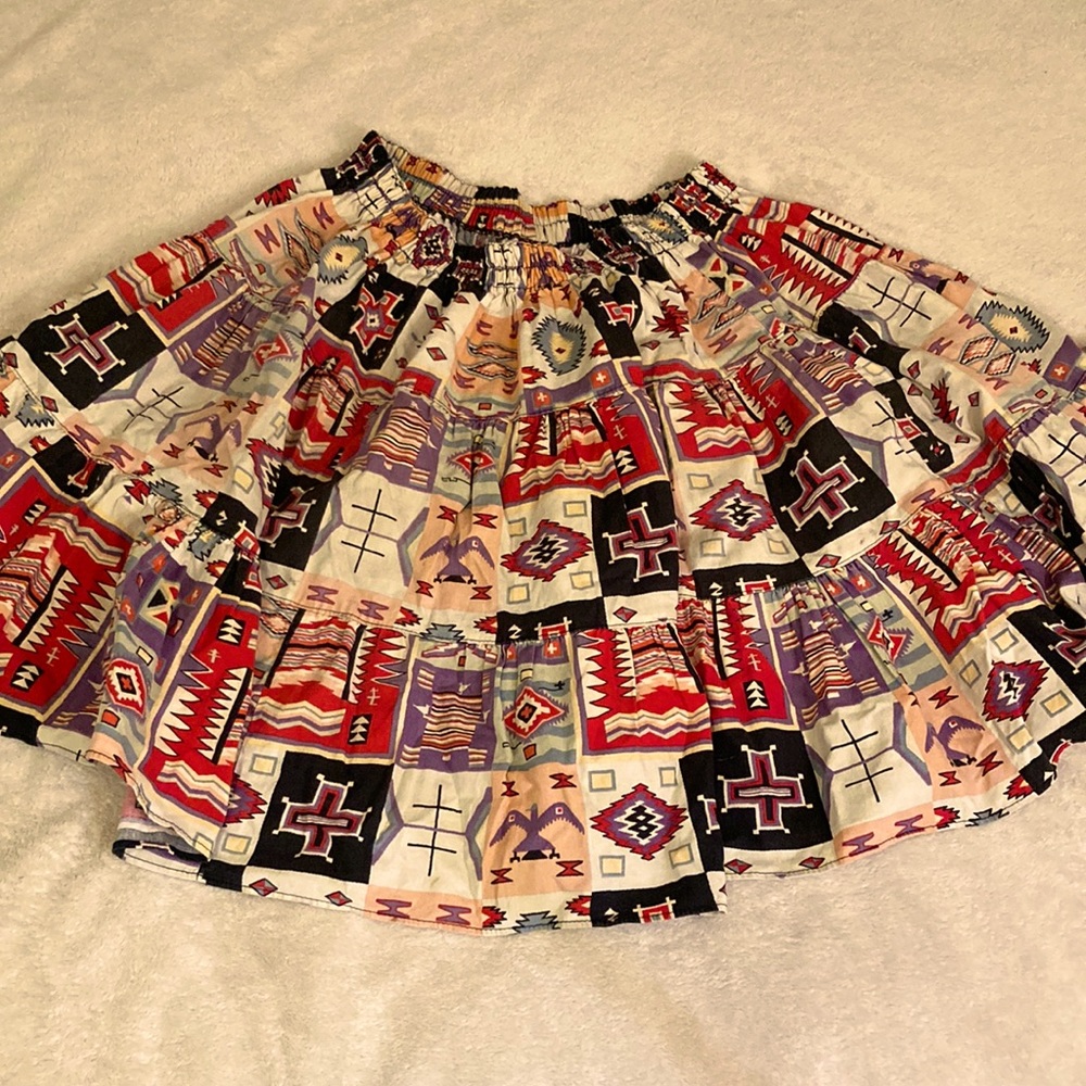 Knee-length full circle skirt vaguely Aztec  pattern